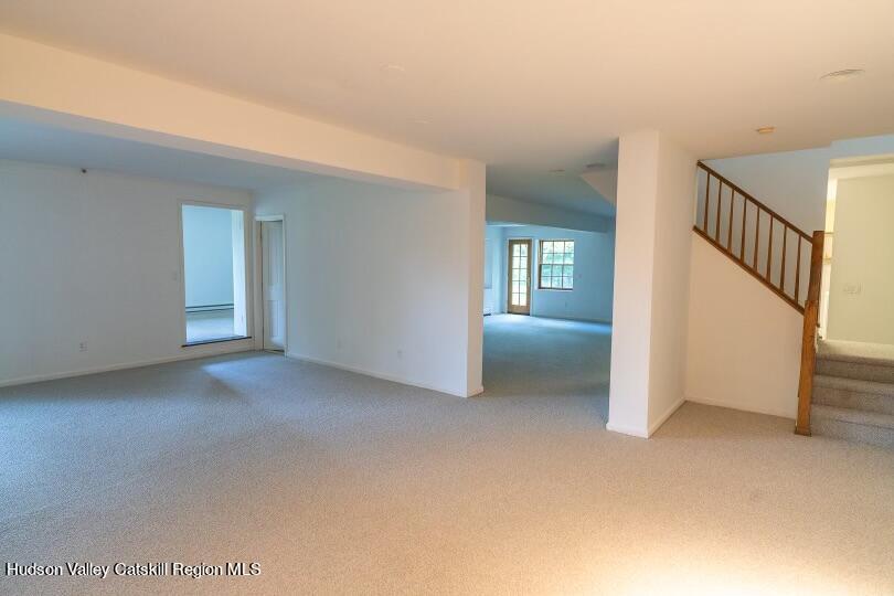 90 Highland Road Stone Ridge, NY 12484 - Photo 21 of 27 a view of an empty room with a fireplace and windows