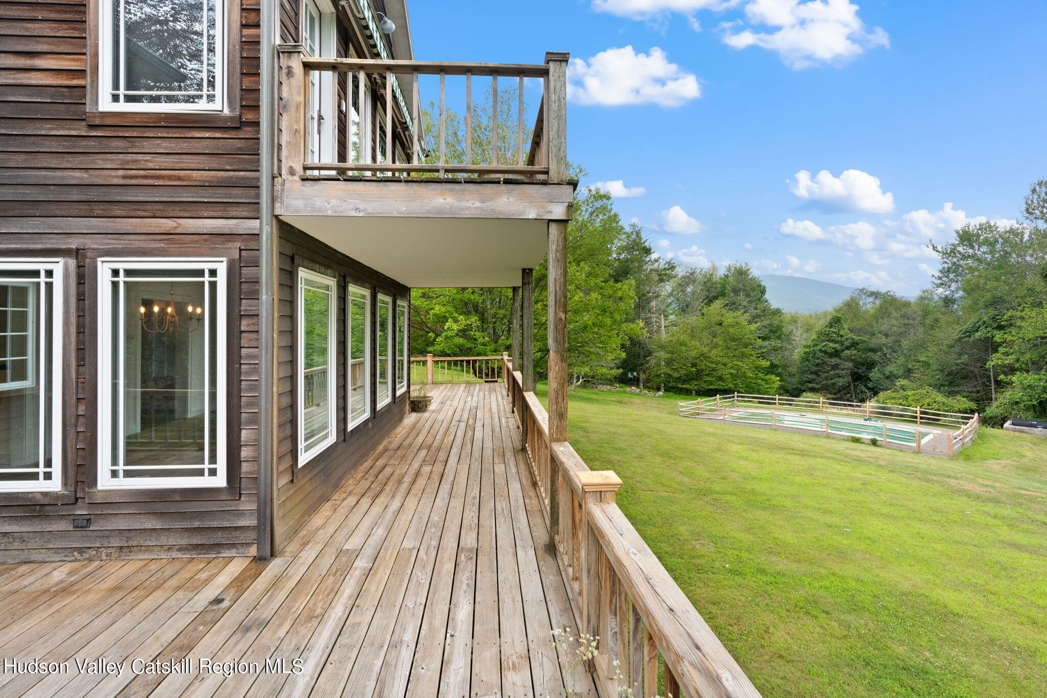 90 Highland Road Stone Ridge, NY 12484 - Photo 22 of 27 a view of a house with pool and wooden deck