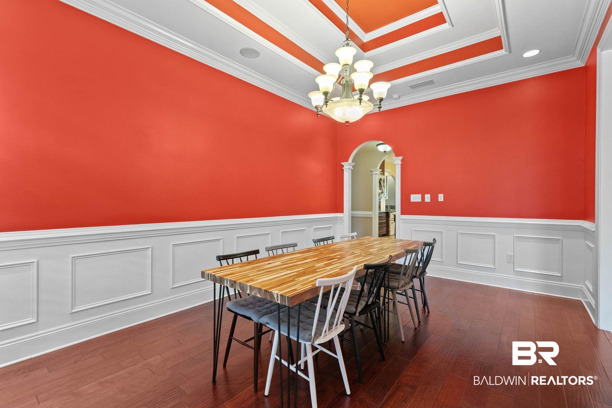 3668 Claridge Road North Mobile, AL 36608 - Photo 32 of 100 Dining room with arched walkways, ornamental molding, dark wood-style floors, a chandelier, and a raised ceiling
