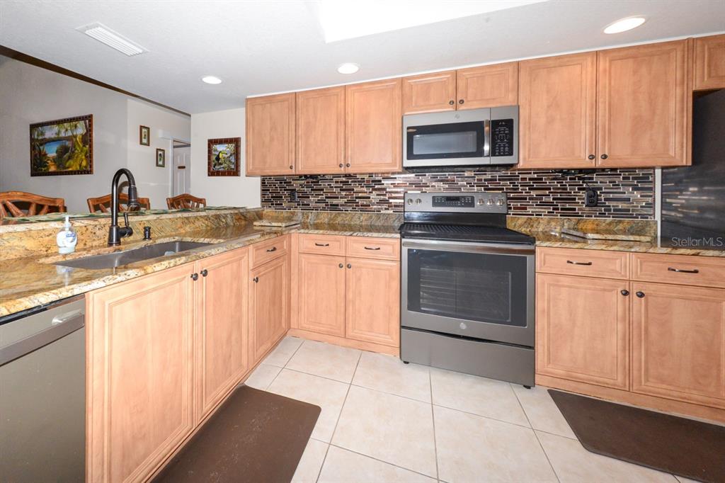 335 Coldeway Drive, Unit F21 Punta Gorda, FL 33950 - Photo 5 of 45 a kitchen with cabinets appliances and a sink