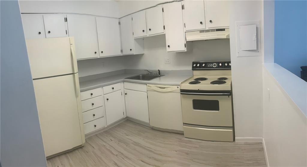 2120 Greentree Road, Unit TE11 Pittsburgh, PA 15220 - Photo 6 of 23 a kitchen with white cabinets and white appliances