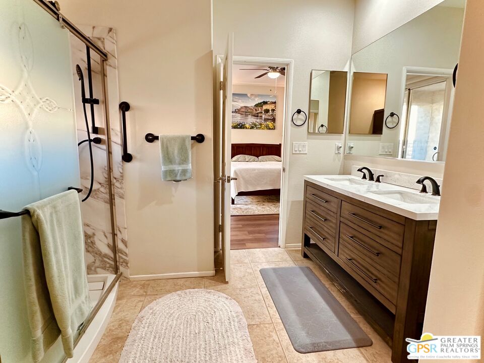 83530 Fenton Court Indio, CA 92203 - Photo 11 of 14 a bathroom with a sink a mirror and shower