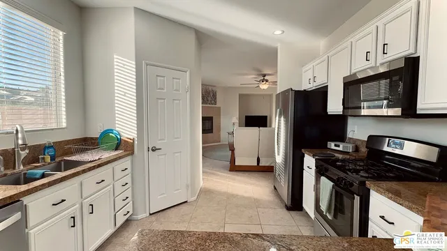 a kitchen with stainless steel appliances a refrigerator sink and stove