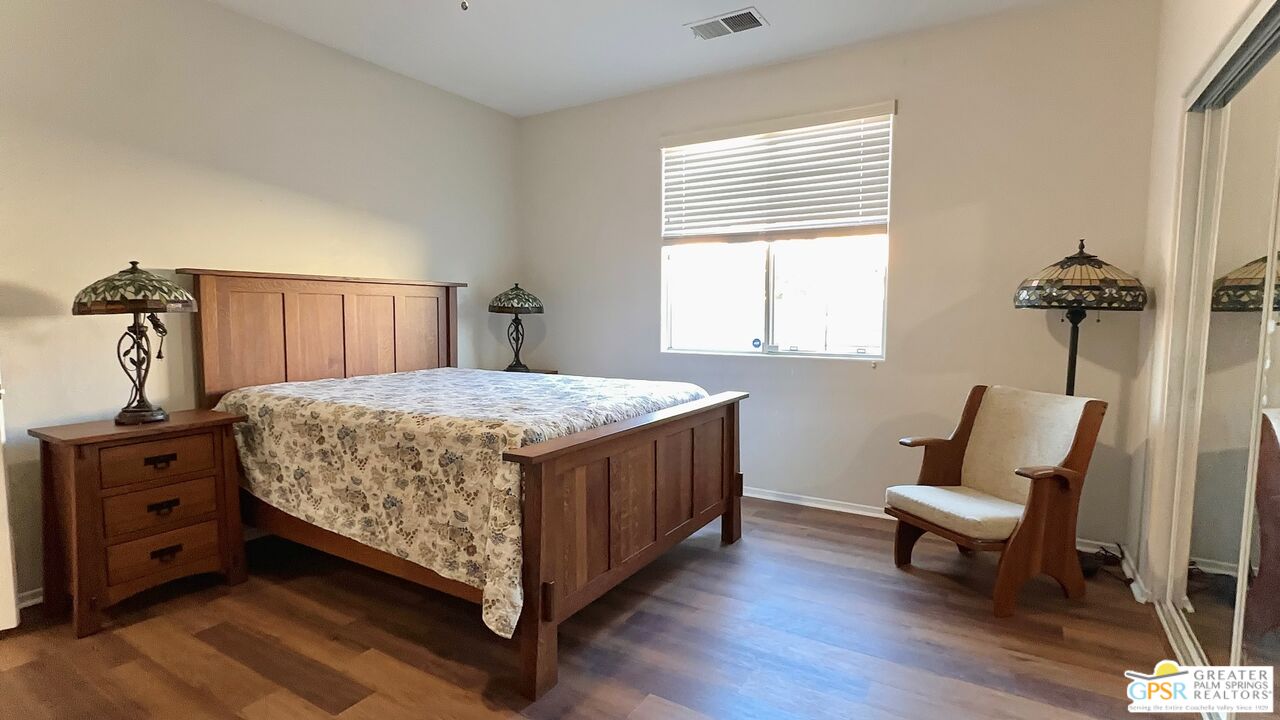 83530 Fenton Court Indio, CA 92203 - Photo 7 of 14 a bedroom with a bed a couch and dresser