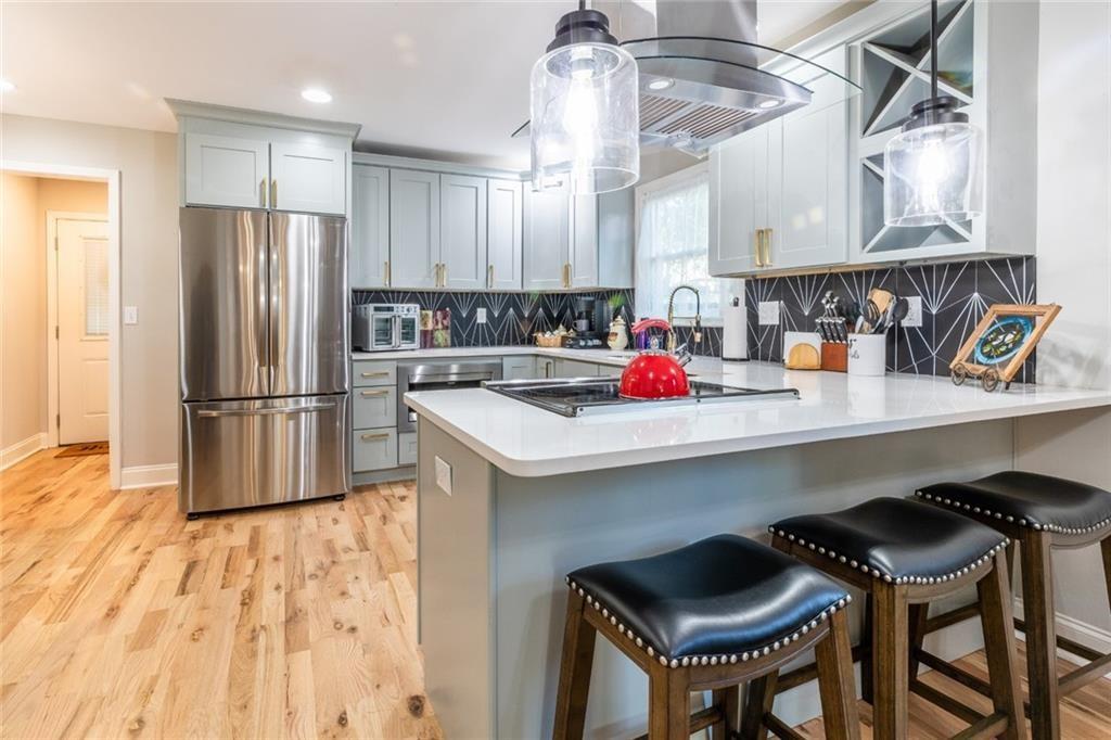 955 Coleman Street Southwest Atlanta, GA 30310 - Photo 20 of 56 a kitchen with stainless steel appliances a sink and a refrigerator