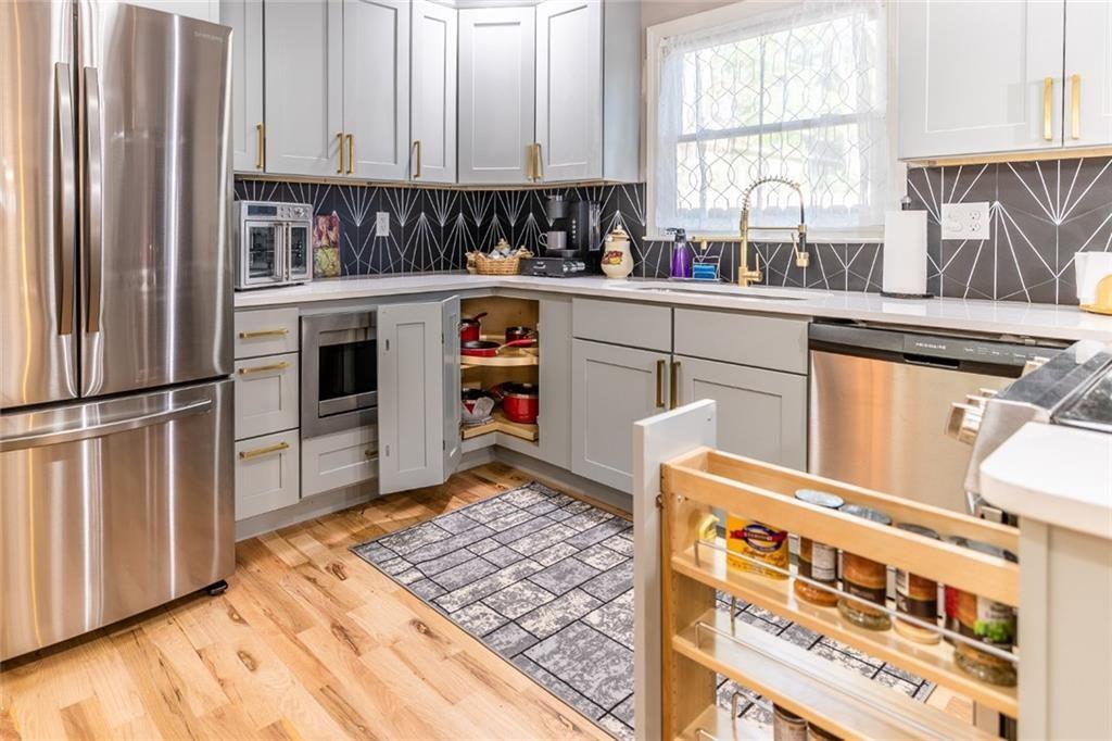 955 Coleman Street Southwest Atlanta, GA 30310 - Photo 23 of 56 a kitchen with stainless steel appliances a sink and a stove