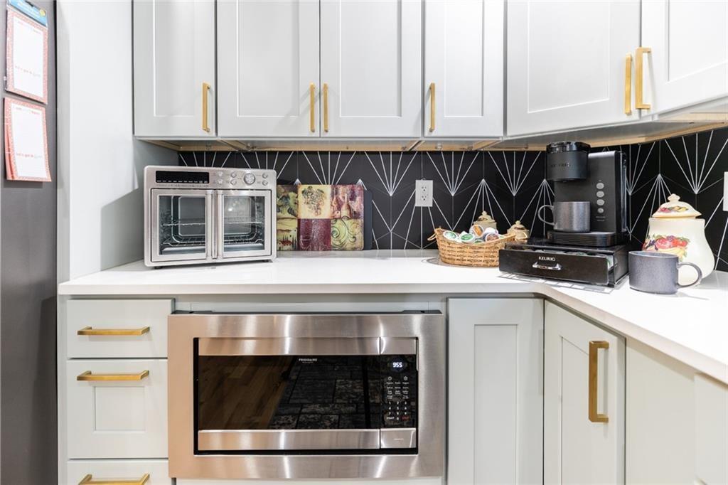 955 Coleman Street Southwest Atlanta, GA 30310 - Photo 25 of 56 a kitchen with a stove and white cabinets