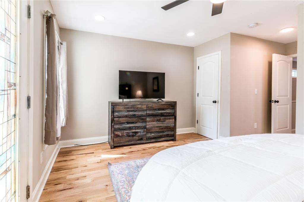 955 Coleman Street Southwest Atlanta, GA 30310 - Photo 39 of 56 a bedroom with a bed and a flat screen television