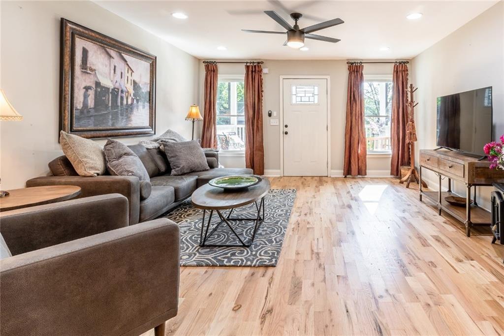 955 Coleman Street Southwest Atlanta, GA 30310 - Photo 10 of 56 a living room with furniture a flat screen tv and a wooden floor
