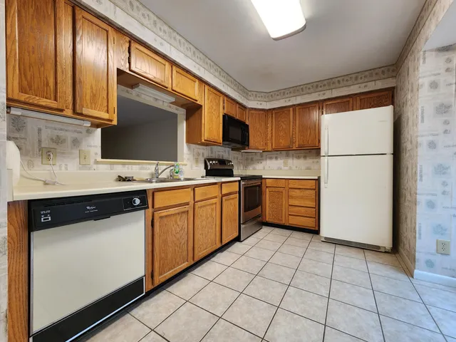 a kitchen with a sink appliances and cabinets