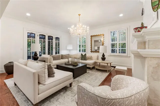 a living room with furniture and a chandelier