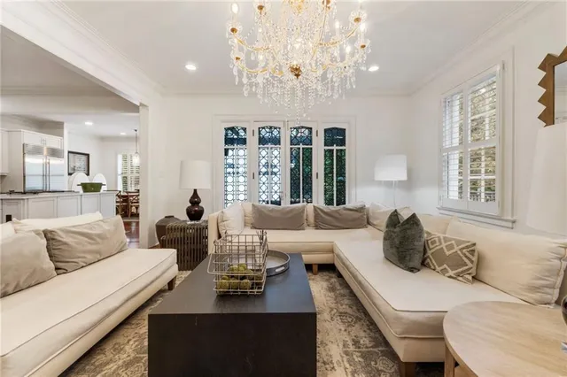 a living room with furniture and a chandelier