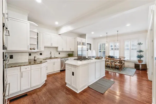 a kitchen with a sink cabinets and wooden floor