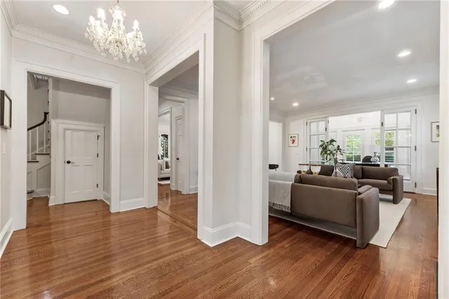 a living room with furniture and a chandelier