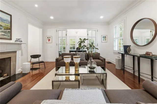 a living room with furniture a large window and a fireplace