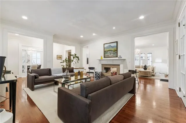 a living room with furniture a fireplace and a large window