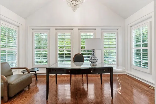 a living room with furniture and floor to ceiling windows