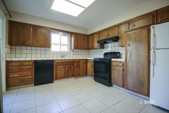 237 South American Street Ridgecrest, CA 93555 - Photo 7 of 26 a kitchen with stainless steel appliances granite countertop a stove sink and refrigerator