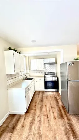 a kitchen with granite countertop a refrigerator and a stove