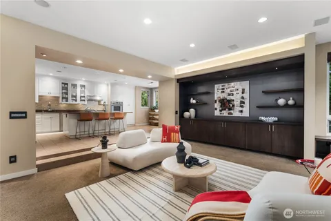 a living room with furniture and a view of kitchen