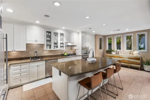 a kitchen with stainless steel appliances granite countertop a sink and a counter top space
