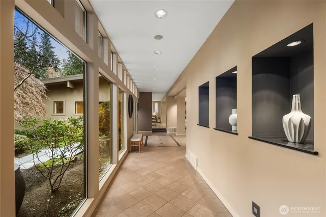 a view of a hallway with dining area and chandelier