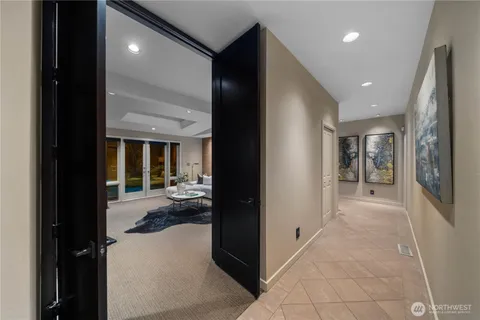 a living room with furniture and a floor to ceiling window