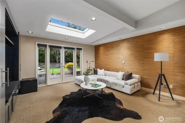 a living room with furniture and a view of kitchen