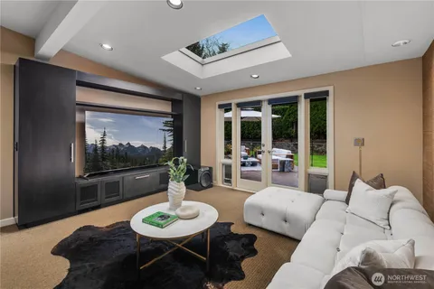 a spacious bedroom with a bed and large glass window