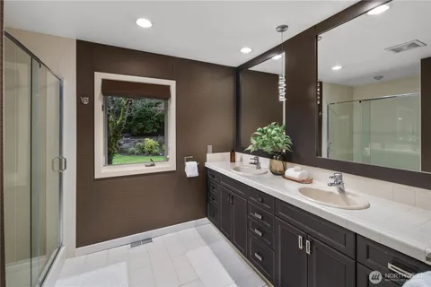 a bathroom with a shower sink and mirror