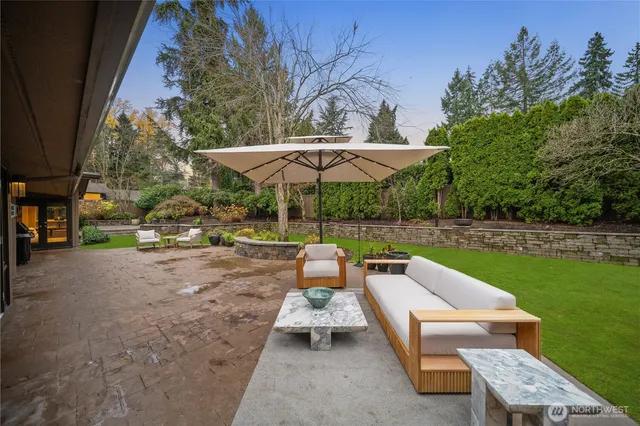 a backyard of a house with yard table and chairs