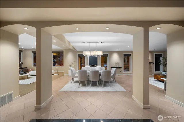 a view of a dining room with furniture a chandelier and wooden floor
