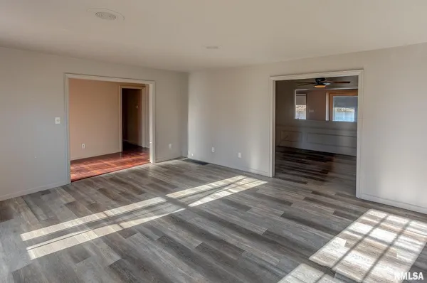 a view of an empty room and wooden floor