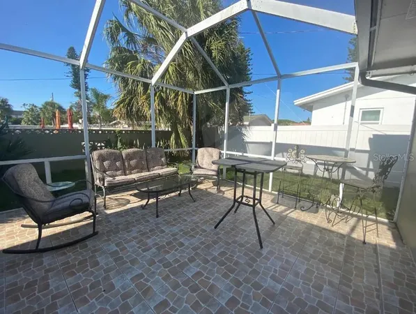 a view of a chairs and table in the patio