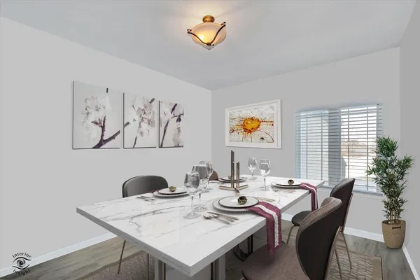 a dining room with furniture and a potted plant