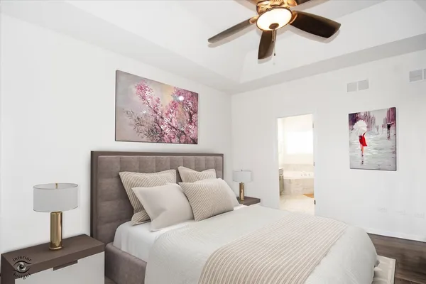 a bedroom with a large bed and a chandelier