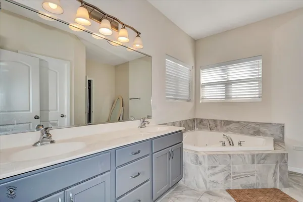 a bath room with a sink and a mirror
