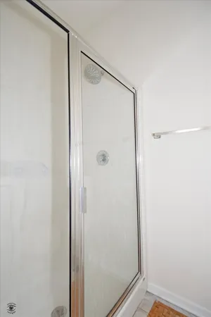 a bathroom with a glass shower door
