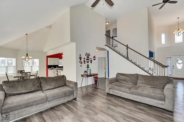 a living room with furniture and a ceiling fan