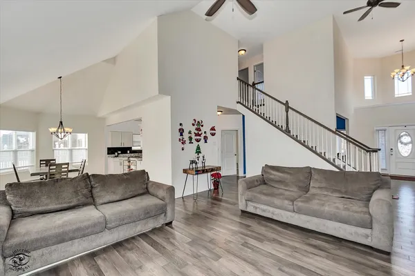 a living room with furniture and a chandelier