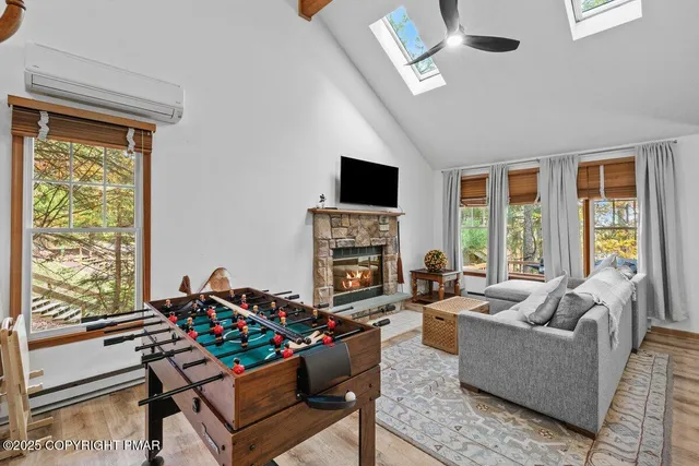 a living room with furniture and a floor to ceiling window