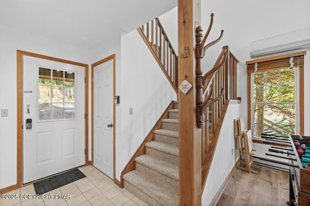 a kitchen with stainless steel appliances kitchen island a table chairs in it and wooden floor