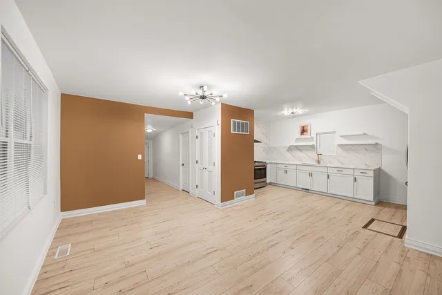a view of a kitchen with wooden floor and a sink