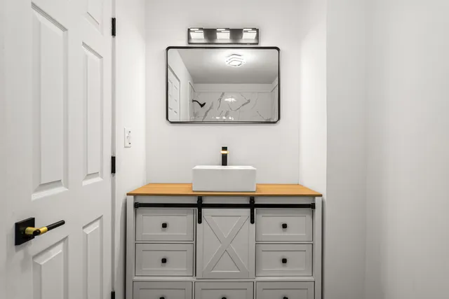 a bathroom with a sink and a mirror