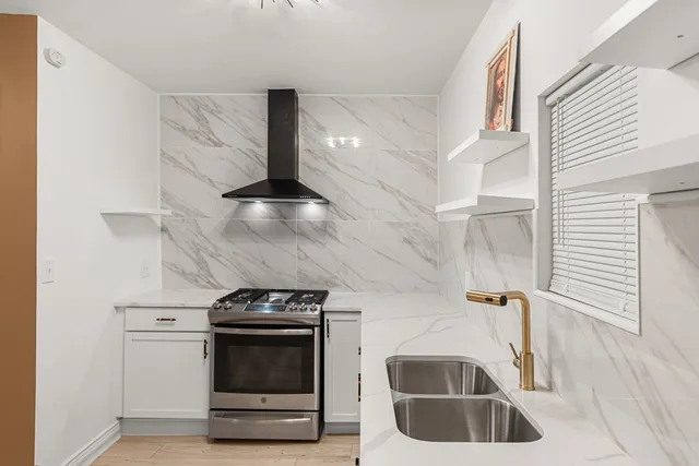 a kitchen with granite countertop a stove and a sink