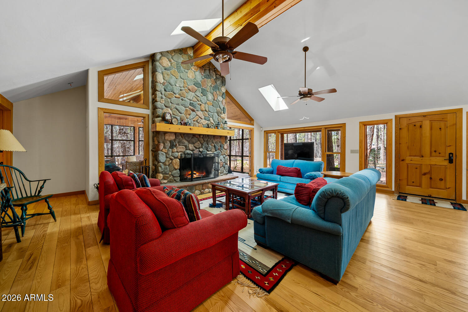 2539 Butterfly Lane Pinetop, AZ 85935 - Photo 14 of 61 a living room with furniture a ceiling fan and a fireplace