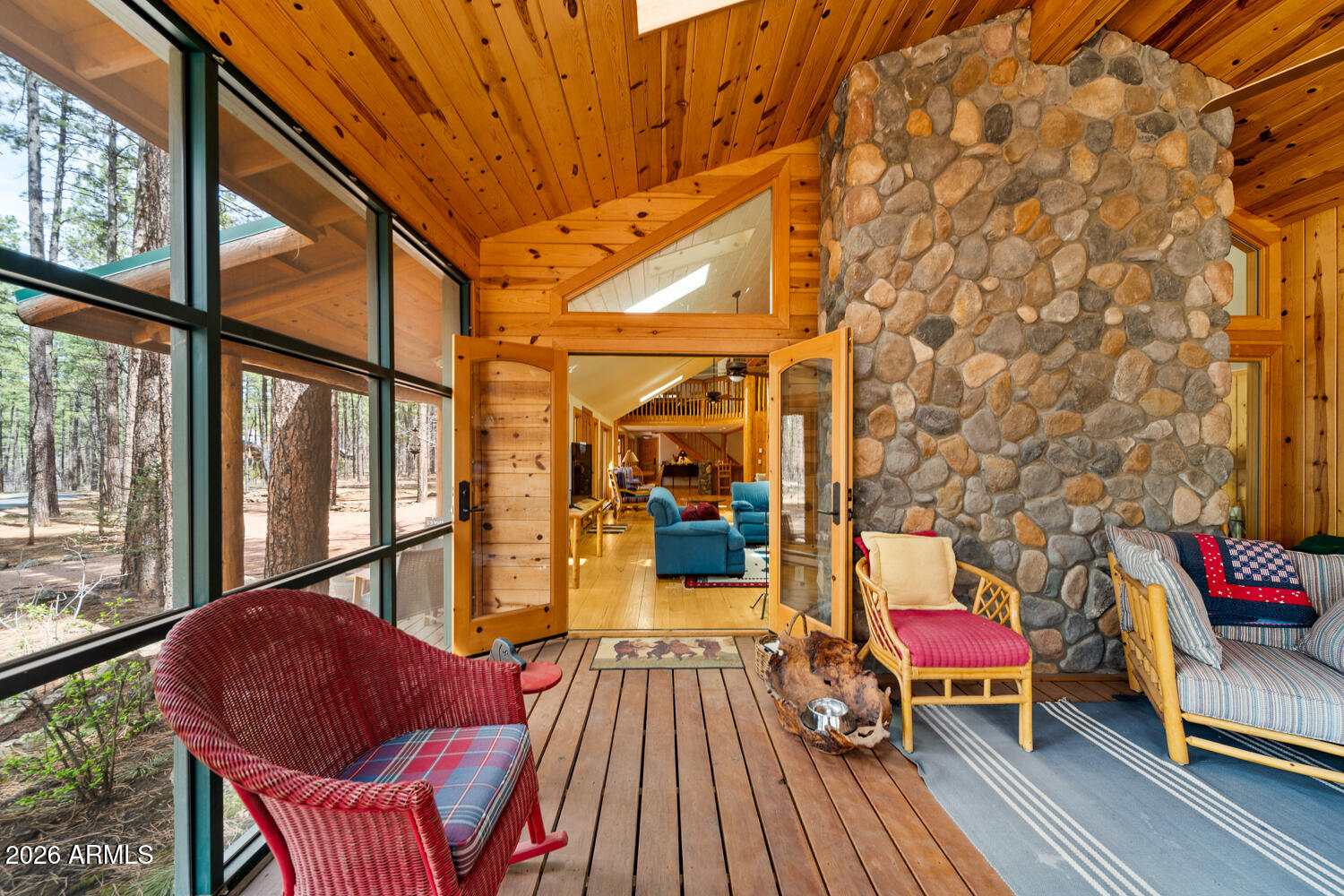 2539 Butterfly Lane Pinetop, AZ 85935 - Photo 21 of 61 a view of a balcony with couch and wooden floor