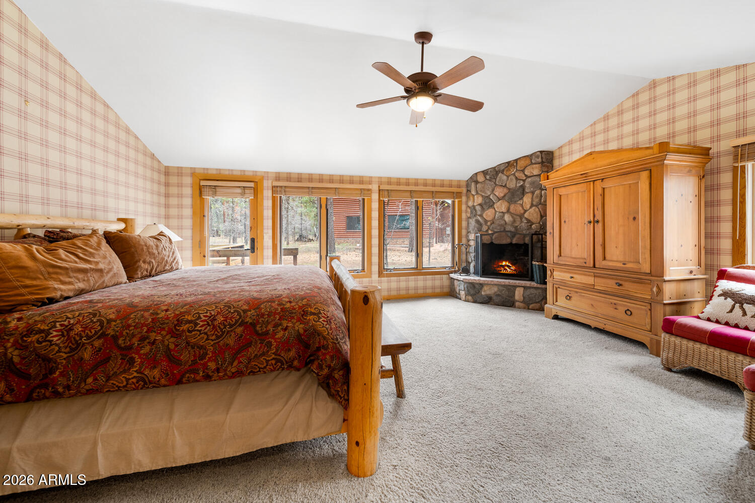 2539 Butterfly Lane Pinetop, AZ 85935 - Photo 25 of 61 a spacious bedroom with a bed and a chandelier