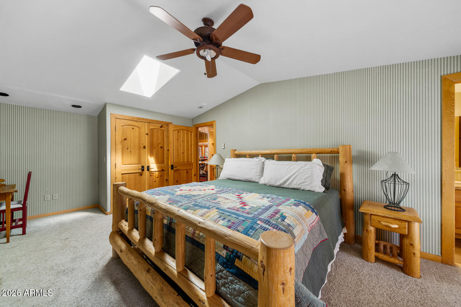 2539 Butterfly Lane Pinetop, AZ 85935 - Photo 30 of 61 a bedroom with a bed a chandelier and a dresser