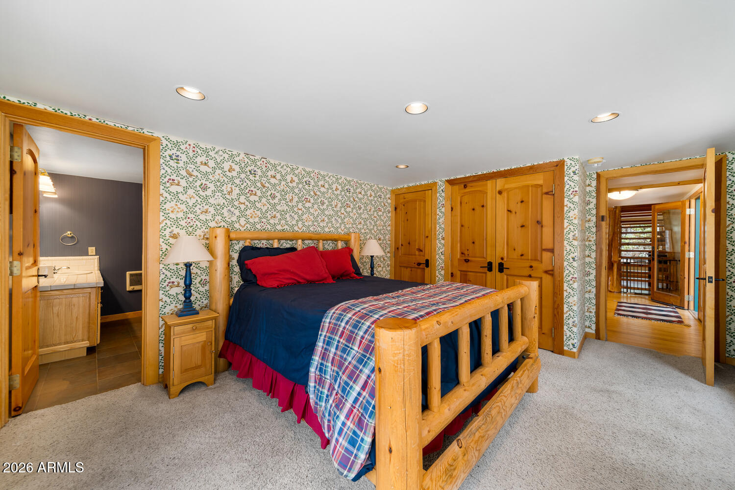 2539 Butterfly Lane Pinetop, AZ 85935 - Photo 47 of 61 a bedroom with a bed and a view of en suite bathroom